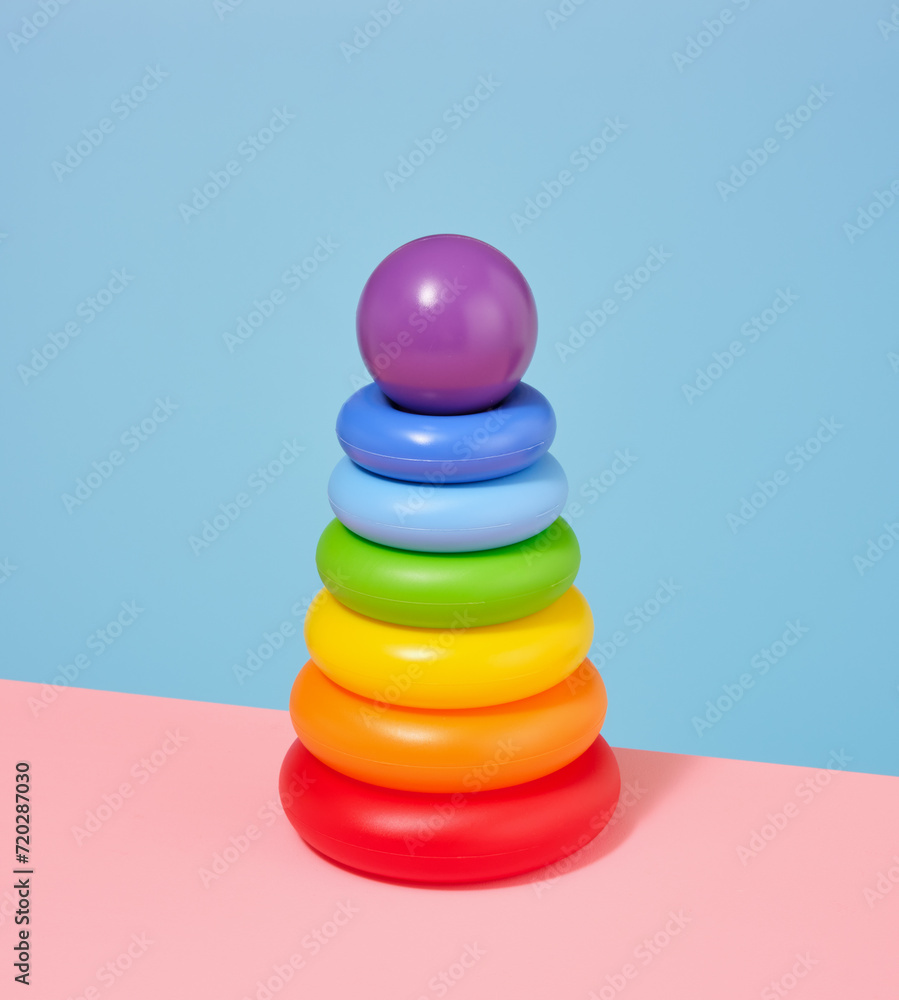 Composition with pyramid, colored rings and round purple ball. Play time. Composition with pyramid, colored rings and round purple ball. Play time.