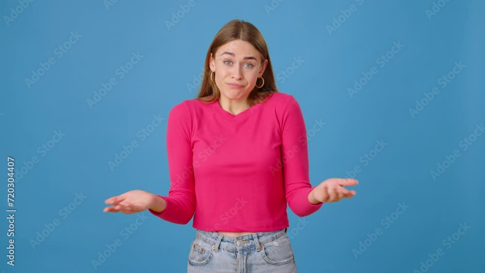 Indecisive female connecting fingers and shrugging in studio Indecisive female connecting fingers and shrugging in studio
