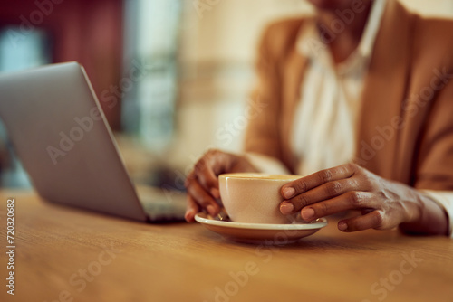 Close-up of a cup of coffee, woman holding with her hands.