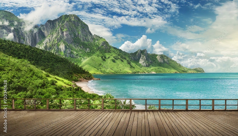 wide view of green mountainous beach in front of sea in summer, cloudy sky, with wooden terrace