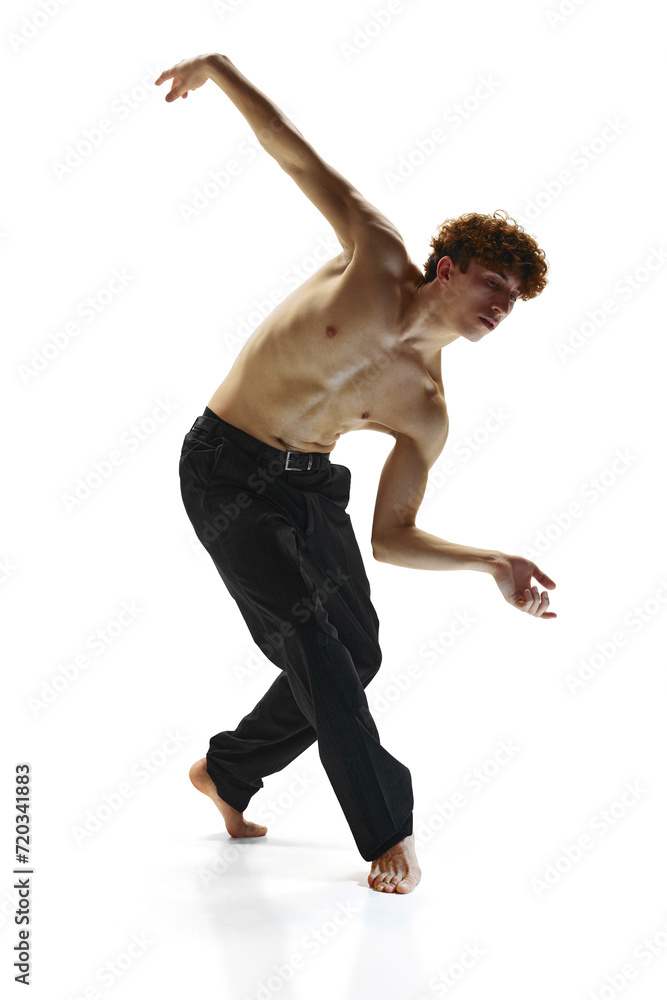 Contemporary dance performances. Male dancer in black pants, bending toward in dance pose against white studio background. Concept of human motions, wellness, natural beauty of male body. Contemporary dance performances. Male dancer in black pants, bending toward in dance pose against white studio background. Concept of human motions, wellness, natural beauty of male body.
