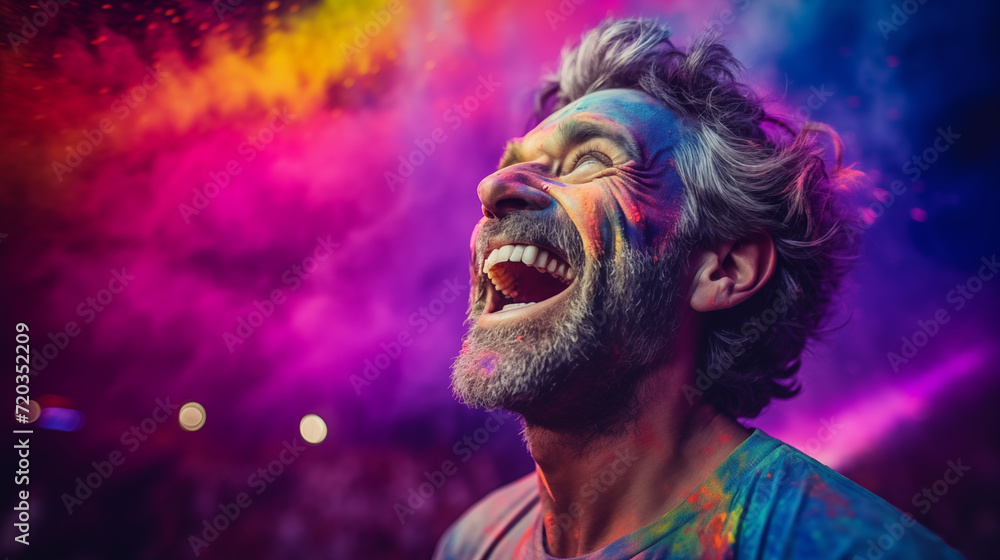 Cheerful man at the festival of colors Holi