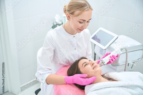 Cosmetology procedure, woman working with customer in clinic