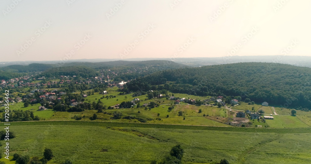 Aerial View of Landscape and Small City agains Mountains