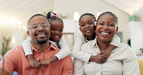Black family, face and happy with parents and children at home, love and bonding with hug and spending time together. Man, woman and girl kids, happiness and portrait and people smile in living room photo