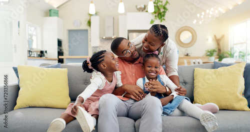 Happy, black family on sofa and in living room of their home happy together for care. Support or love, happiness or positivity and African people cuddle on couch in their house for bonding time photo