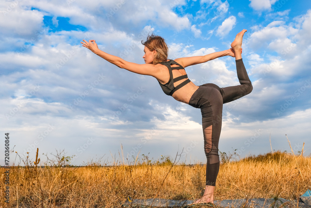 Slender blonde girl doing yoga outside Slender blonde girl doing yoga outside