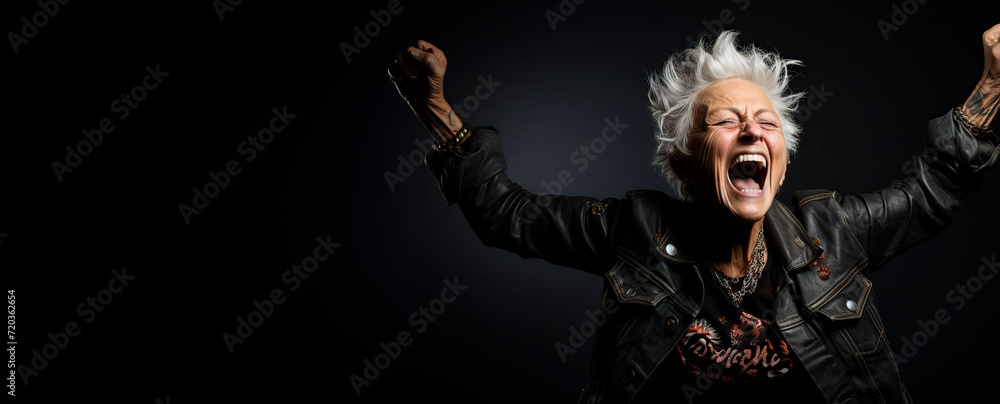 Senior rocker woman dancing over black background. Copyspace Senior rocker woman dancing over black background. Copyspace