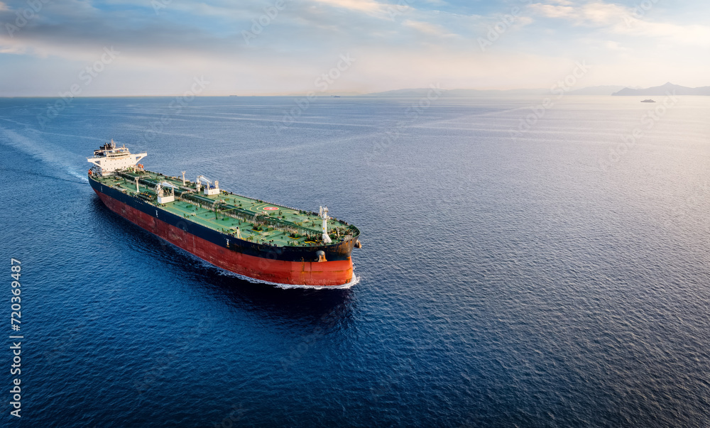 Aerial view of a large crude oil tanker traveling over open ocean with copy space