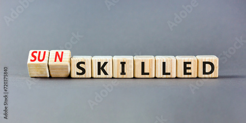 Sun skilled symbol. Concept words Skilled or Sun skilled on beautiful wooden blocks. Beautiful grey table grey background. Business sun skilled concept. Copy space.