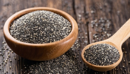 A wooden spoon is filled with black seeds photo