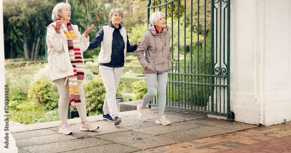 Fototapeta premium Senior friends, walking and talking together on an outdoor path to relax in nature with elderly women in retirement. People, happy conversation and healthy exercise in the park in autumn or winter