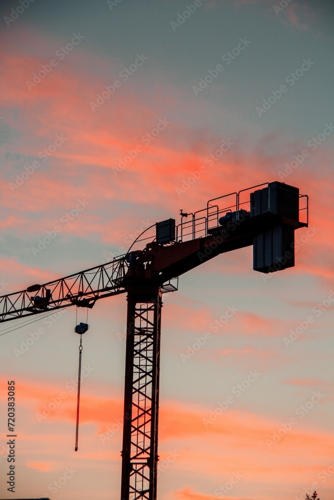 Vertical Shot Industrial Construction Crane During Sunset 1