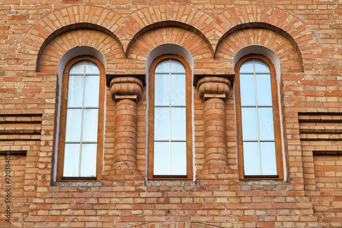 Fragment of a historical building with 3 side-by-side vertical windows © watcherfox