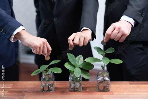 Картината върху платно Business people put money saving into jar filled with coins and growing plant for sustainable financial planning for retirement or eco subsidy investment for environment protection