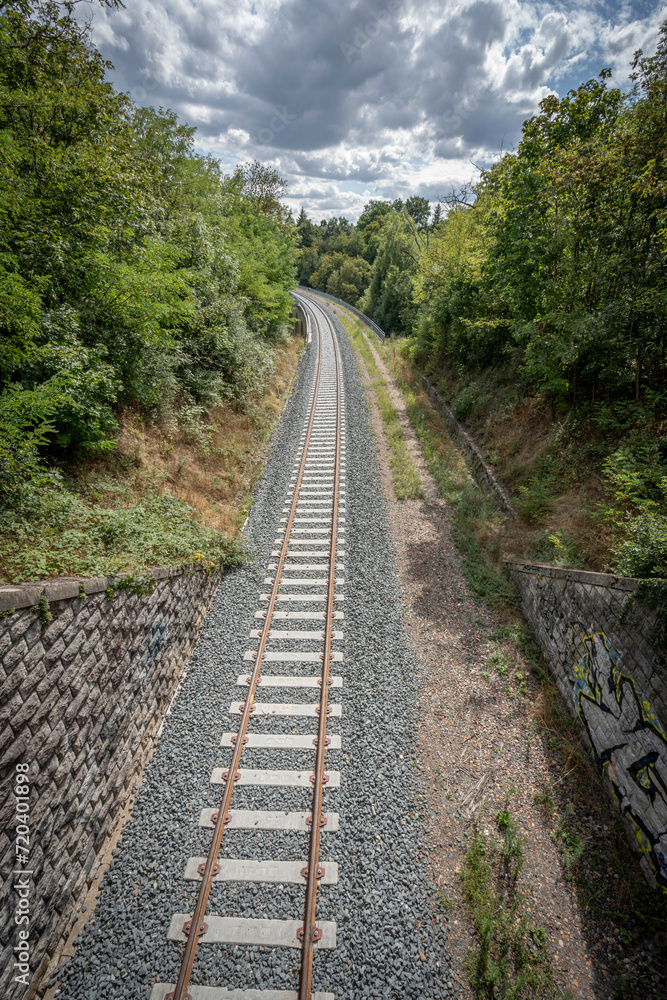 Obraz premium Dardilly, France - 08 05 2023: View of a railway track across the forest.