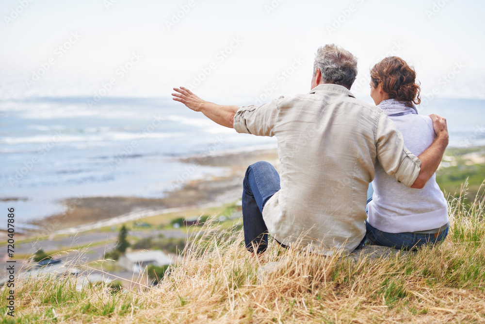 Old couple and pointing at nature on holiday, vacation or embrace with love or support in retirement. Back, man and woman together sightseeing on hill at beach or relax in environment and adventure Old couple and pointing at nature on holiday, vacation or embrace with love or support in retirement. Back, man and woman together sightseeing on hill at beach or relax in environment and adventure