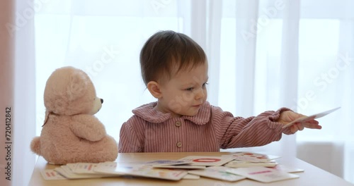 little child girl playing developing game with flashcards numbers, learning to count