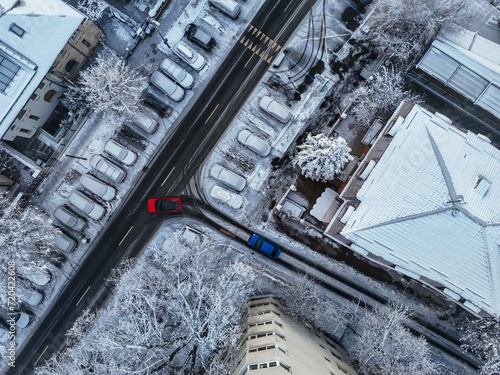Aerial view of Bucharest City in winter season. Drone Aerial view over Bucharest city. Snowy day over blocks, streets and parking lot. Blizzard day in the city. Frozen block of flats in Bucharest. 