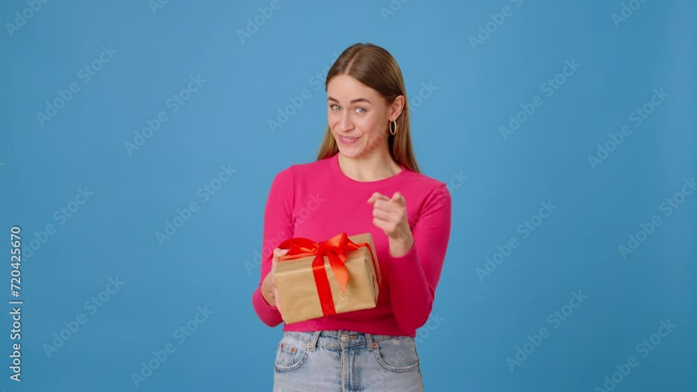 Woman showing gift box and feeling excited in studio Woman showing gift box and feeling excited in studio