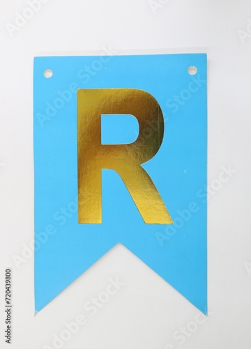 Letter R uppercase - golden color font on blue background