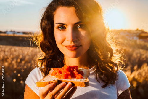 Sunset Snack A Person Enjoying Bread with Tomato Topping