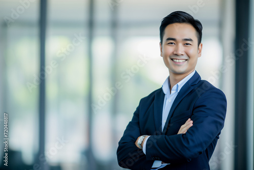 Smiling Thai businessman with office background. photo