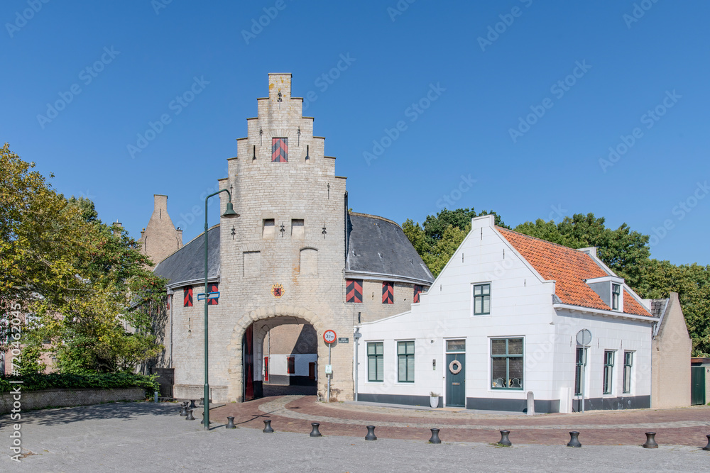Entrance through the historic Noordhavenpoort of the city of Zierikzee, the Netherlands leading to the Zuidhavenpoort on the harbour against a clear blue sky