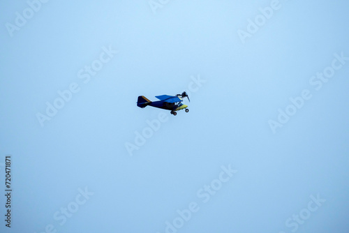Propeller airplane is flying against isolated blue sky