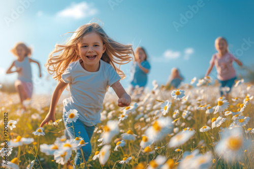 Fototapeta Naklejka Na Ścianę i Meble -  Laughing children running through a blooming meadow on a warm and sunny day