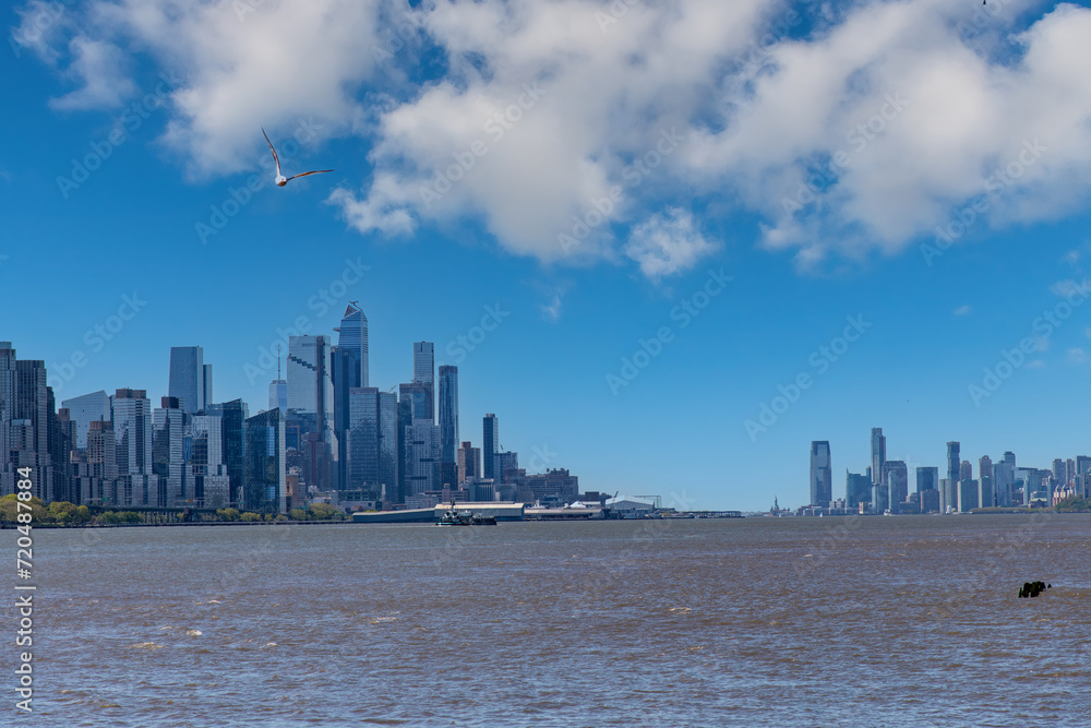 Panoramic view over the Hudson River in southerly direction towards lower Manhattan New York City, USA with skyline of skyscrapers on left and Jersey City skyscrapers on right
