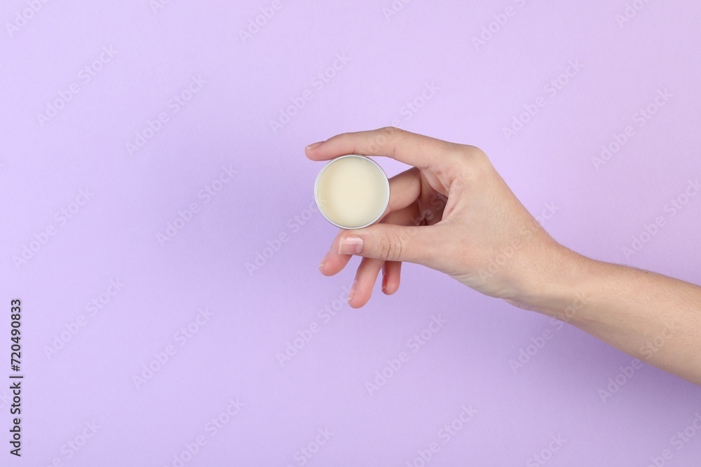 Woman with lip balm on violet background, closeup Woman with lip balm on violet background, closeup