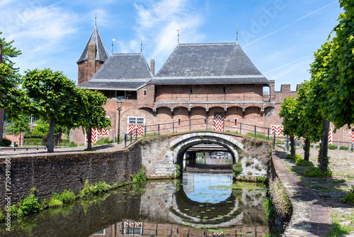 View over Eem canal towards the medieval gate Koppelpoort in Amersfoort, the Netherlands that combines land and water-gates and is part of the second city constructed between 1380 and 1450 photo