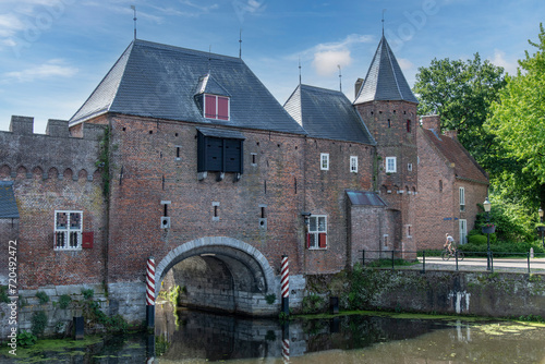 View over Eem canal towards the medieval gate Koppelpoort in Amersfoort, the Netherlands that combines land and water-gates and is part of the second city constructed between 1380 and 1450 photo