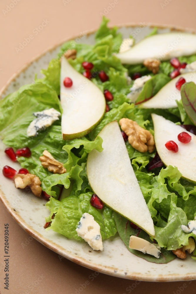 Delicious pear salad on beige background, closeup