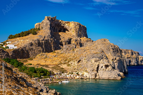The Acropolis of Lindos and the beach in St. Paul's Bay in Rhodes. © M-Production