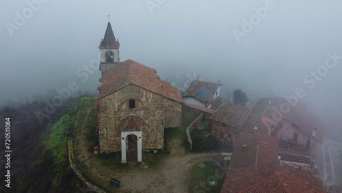 Sarezzano, small ancient village with its church shrouded in fog - Tortona - Alessandria - Piedmont - Italy