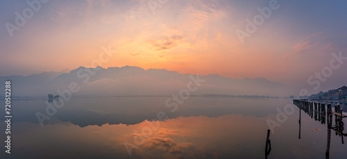 Panoramic landscape of Dal Lake nestled in Himalayas mountain range during sunrise on autumn morning from lake view point at Srinagar, Jammu and Kashmir, India. photo