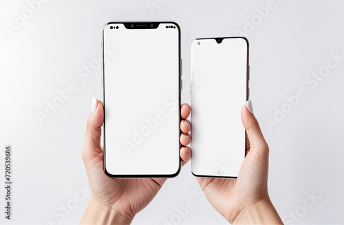 Woman hand holding the black smartphone with blank screen and modern frameless design two positions angled and vertical - isolated on white background photo