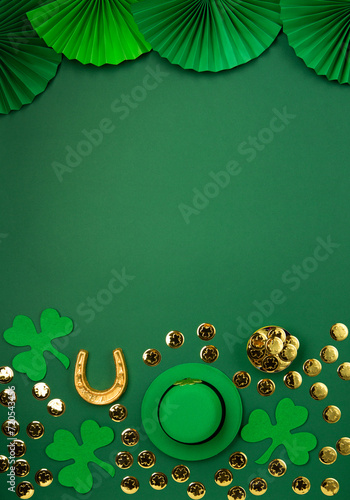 St. Patrick's Day Leprechaun Hat, Gold Coins, Shamrocks and Party Favors on Green Background.