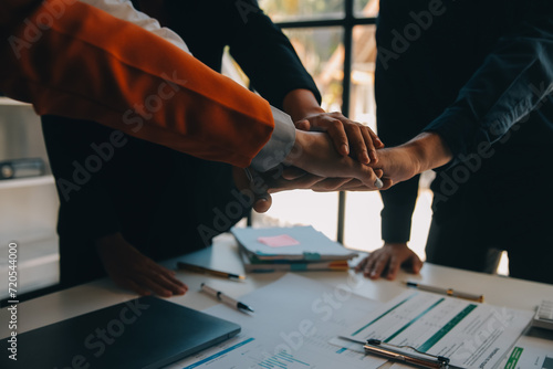 Large business team showing unity with their hands together photo