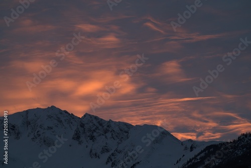 beautiful sunset with a red sky in the mountains at a winter evening