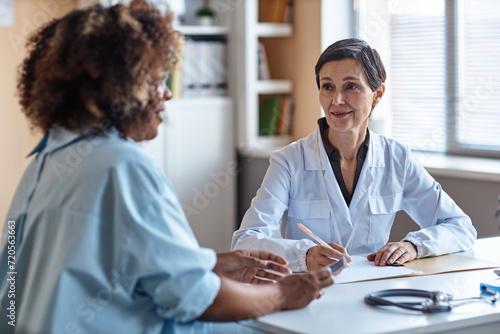 Bild auf Leinwand Medium shot of smiling woman gynecologist consulting African American female pat