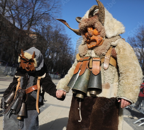 Pernik, Bulgaria - January 26, 2024: International masquerade festival Surva in Pernik, Bulgaria. People with mask called Kukeri dance and perform to scare the evil spirits. photo