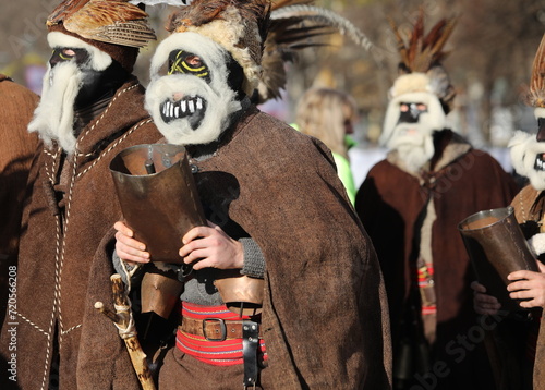 Pernik, Bulgaria - January 26, 2024: International masquerade festival Surva in Pernik, Bulgaria. People with mask called Kukeri dance and perform to scare the evil spirits. photo