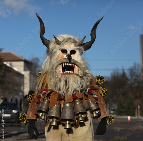 Pernik, Bulgaria - January 26, 2024: International masquerade festival Surva in Pernik, Bulgaria. People with mask called Kukeri dance and perform to scare the evil spirits. photo