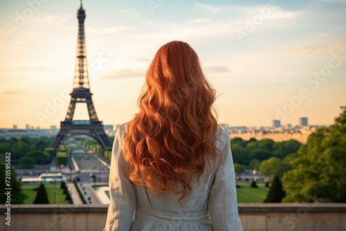 A stunning woman with fiery red hair posing confidently in front of the iconic Eiffel Tower, Young woman's rear view looking at the Eiffel Tower, AI Generated