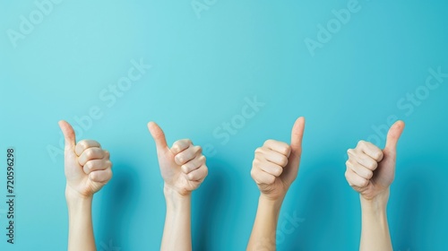 Human hands showing thumbs up isolated on turquoise background. Gesture and body parts concept.