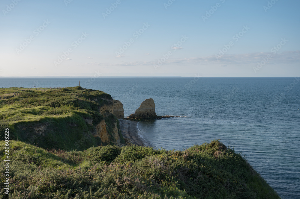 The cliff of Pointe du Hoc in Normandy, France. Memorial of heroic assault of the 2nd Ranger battalion on D-Day of artillery battery at Point Du Hoc threatening allied landings on Utah Beach and Omaha The cliff of Pointe du Hoc in Normandy, France. Memorial of heroic assault of the 2nd Ranger battalion on D-Day of artillery battery at Point Du Hoc threatening allied landings on Utah Beach and Omaha