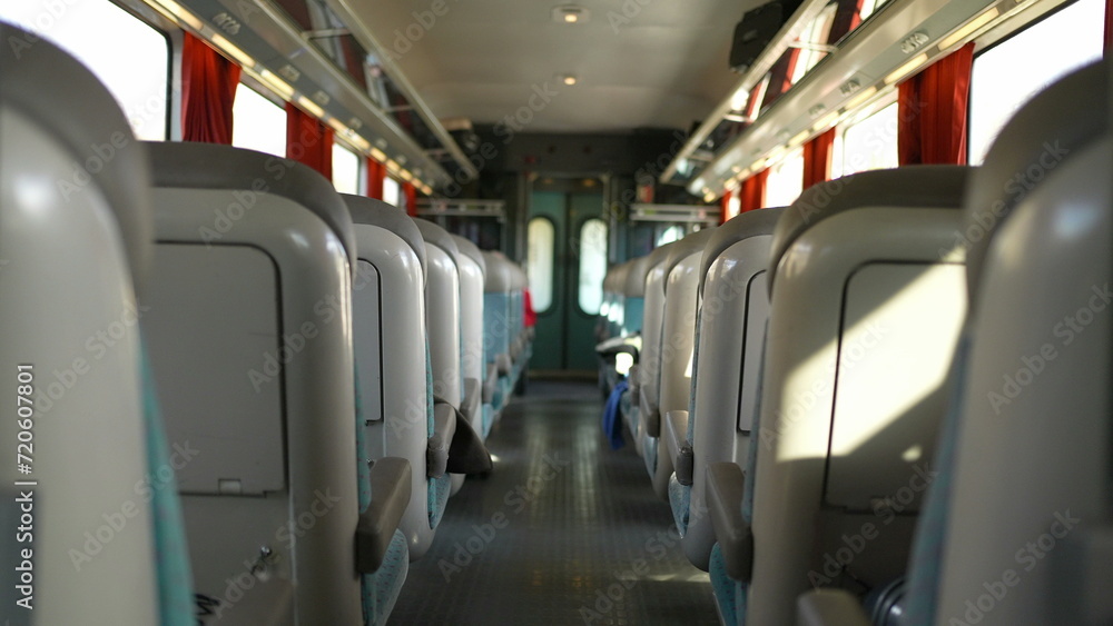 Obraz premium Passenger perspective walking through train corridor in movement, POV of person inside high-speed transportation traveling